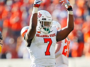 STILLWATER, OK - SEPTEMBER 26:  Linebacker Amen Ogbongbemiga #7 of the Oklahoma State Cowboys celebrates after sacking quarterback Jarret Doege #2 of the West Virginia Mountaineers in the fourth quarter on September 26, 2020 at Boone Pickens Stadium in Stillwater, Oklahoma.