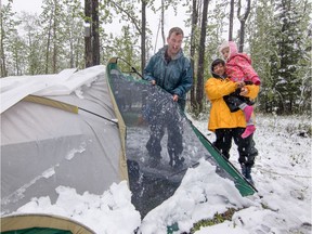 It isn't difficult to find examples of when the weather didn't co-operate with May long weekend plans in southern Alberta. Here, Shane Pap, Anouk Bray and dad Don Bray shake the snow from their tent at Paddy's Flat campground west of Bragg Creek on Sunday May 22, 2016. Mike Drew/Postmedia