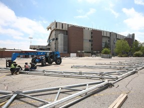 Workers with Warner Shelter Systems Limited assemble framing for the Nashville North tent on the Calgary Stampede grounds on Wednesday, May 26, 2021.