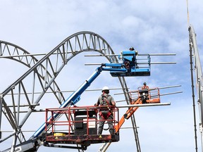 Employees from Warner Shelter Systems Limited work on the Nashville North structure on the the Stampede grounds in Calgary on Thursday, May 27, 2021.