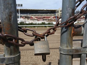 A padlock is shown on a gate leading from the barns area to the backstretch of the track at the infield area at the Stampede grounds in Calgary on Thursday, May 27, 2021.
