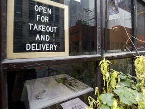 A sign inside a Toronto restaurant closed to in-person dining by provincial order.