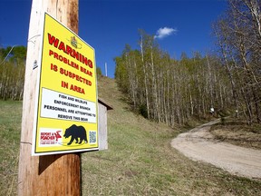 A bear trap and signs set up on TWP RD 291 off of Jack Eby Trail just S.W. of Water Valley where a woman was attacked and killed by a grizzly bear on Wednesday, May 26, 2021.