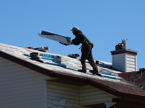 Roofers work in Saddleridge on Monday, May 10, 2021. Repairs continued on damaged homes in northeast Calgary neighbourhoods after last year’s massive hail storm.