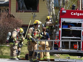 Calgary firefighters clean up after a fire in a duplex in Ranchlands on Wednesday, May 12, 2021.