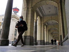Pedestrians walk under the arches of the Hudson’s Bay store in downtown Calgary on Thursday, May 13, 2021. Both the City of Calgary and the provincial government are looking at ways to revitalize the downtown core.