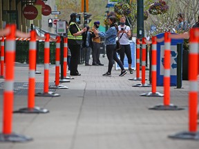 Calgarians check in at the COVID-19 vaccination clinic at the Telus Convention Centre on Monday, May 17, 2021.