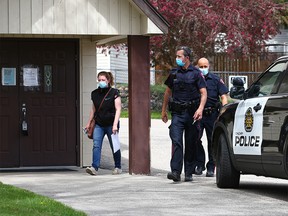 Calgary police officers were with an Alberta Health Services official who was attaching closed to the public signs to doors at Fairview Baptist Church on Monday, May 17, 2021. Church Pastor Tim Stephens was arrested on Sunday after repeatedly failing to comply with public health restrictions.