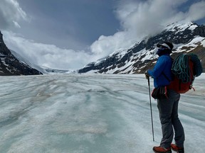 An image of Chris Girard, a guide with Rockaboo Mountain Adventures hiking on the Athabasca Glacier in Jasper National Park in Alberta, Canada.