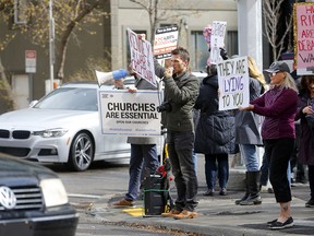 Anti-restriction protesters on a street corner in downtown Calgary on May 4, 2021.