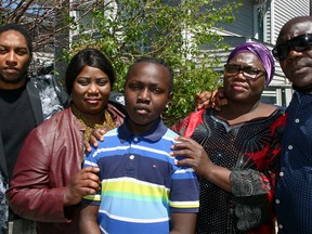 From left, Adam Massiah, a member of the Calgary Police Service anti-racism committee, auntie Reia Silvane, mother Joice Wolter and uncle Mathew Dudu stand with 12-year-old Kobe Amadi in front of the family's NE home. Kobe was aggressively tackled to ground by a Calgary police member in April who wrongfully identified him. Sunday, May 30, 2021.