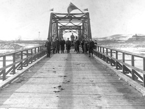 Macleod Trail was a key route for moving supplies and trade decades ago. It crossed the Elbow River at the Victoria Bridge, shown here with several of the city's aldermen standing on the bridge in 1905. Mrs. Jean Gibbs photo, Glenbow Archives NA-976-1.