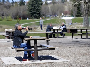Maria Fule enjoys a legal cold drink at Bowness Park as city council approved a pilot project allowing booze consumption in city parks in Calgary on Monday, May 10, 2021.