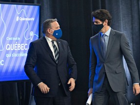 Quebec Premier Francois Legault, left and Prime Minister Justin Trudeau chat after they announced high speed internet for Quebec regions, Monday, March 22, 2021 in Trois-Rivieres Que.