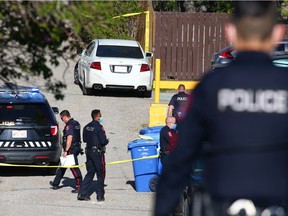 Police investigate a fatal shooting in an alley in the 1800 block of 26th Avenue S.W. in South Calgary on Saturday, May 22, 2021. The victim was shot in a white Acura sedan parked in the alley.