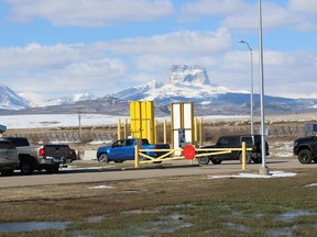 With Chief Mountain in the background a long line of cars are backed up at the Carway Border crossing in southern Alberta on Wednesday April 21, 2021 as First Nations members and others from the general public took advantage of free vaccinations courtesy of the Blackfeet Tribe in Montana. The tribe, 150 kilometres south of Lethbridge, Alberta, already has 98 percent of its members vaccinated and have an abundance of COVID-19 vaccines and received permission to share the excess vaccines with both Canadian First Nations and non-First Nations in the area.