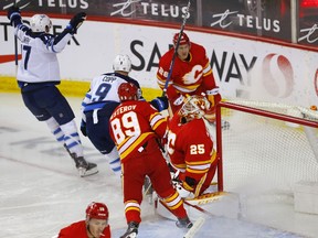 Calgary Flames goalie Jacob Markstrom is scored on by Winnipeg Jets forward Adam Lowry at the Scotiabank Saddledome in Calgary on Wednesday, May 5, 2021.