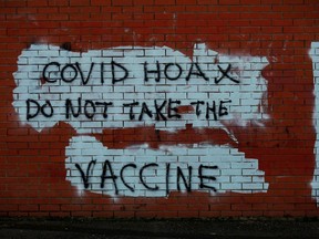 Anti-vaccine graffiti is seen on the wall of a shop amid the outbreak of the coronavirus disease in Belfast, Northern Ireland Jan. 1, 2021.