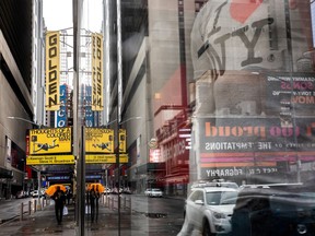 FILE PHOTO: A man walks outside the shuttered John Golden Theatre amid coronavirus disease (COVID-19) pandemic in New York City, U.S., April 12, 2021.  REUTERS/Jeenah Moon/File Photo ORG XMIT: FW1