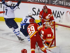 Calgary Flames goalie Jacob Markstrom surrenders a goal to the Winnipeg Jets' Adam Lowry in first-period NHL action at the Scotiabank Saddledome in this photo from May 5.