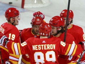 The Calgary Flames celebrate a goal from Rasmus Andersson during first-period NHL action at the Scotiabank Saddledome in Calgary on Thursday. The Flames beat the Vancouver Canucks 4-1.