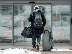 A traveller arrives for a mandatory hotel quarantine near Toronto’s Pearson Airport during the COVID-19 pandemic, February 22, 2021.