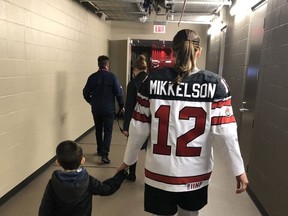 After participating in the Edmonton Oilers' skills challenge in December 2019, Meaghan Mikkelson walks down the hallway at Rogers Place with one of her biggest fans, her son Calder. (Courtesy of Meaghan Mikkelson)