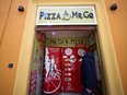 Claudio Zampiga waits for his order at the first automatic pizza vending machine, which is capable of kneading, seasoning and cooking the pizza in three minutes, in Rome, Italy, May 6, 2021.