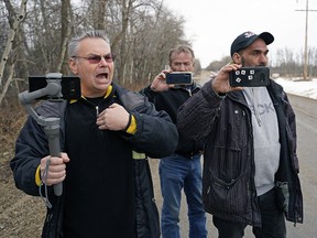 Kevin J. Johnston, left, shouts at journalists near GraceLife Church on Sunday March 14, 2021.