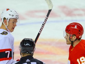 Ottawa Senators forward Brady Tkachuk and Calgary Flames counterpart Matthew Tkachuk during a break in play chat with referee Nicholson Kendrick during NHL hockey in this photo from March 7.