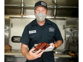 Notorious P.I.G. owner Graham Sherman with some smoked cherry chipotle side ribs. The barbecue truck is located outside the Tool Shed Brewing Company. Brendan Miller/Postmedia