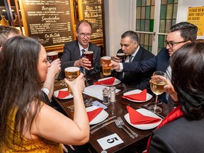 Customers raise a glass inside the re-opened Old Dr Butlers Head pub in London as COVID-19 lockdown restrictions ease across the country on May 17, 2021.