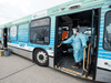 Health-care workers conduct rapid COVID-19 screening on a city bus in the Waterloo Region Friday. The rollout of rapid testing in Canada has been slow, but that is changing.