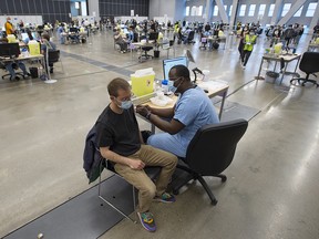 People get vaccinated at the Palais de Congress COVID-19 vaccination clinic in Montreal on Thursday, May 13, 2021.