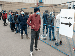 People line up for the COVID-19 vaccination clinic in Toronto on Tuesday May 11, 2021.