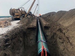 Pipe is laid for the Trans Mountain pipeline expansion project near Edmonton in late December 2019.