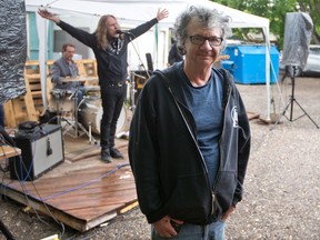 A live jam session plays behind The Blues Can owner Greg Smith at the bar's outdoor stage area on a damp Saturday evening, June 19, 2021.