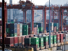 Shipping containers are loaded onto rail cars at the Global Container Terminals Inc. (GCT) Vanterm container terminal in Vancouver, British Columbia, on Saturday, March 21, 2020.