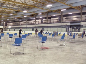 Organizers prepare a pop-up, walk-in COVID-19 vaccine clinic in a hockey rink at Village Square Leisure Centre in northeast Calgary on Wednesday, June 2, 2021.