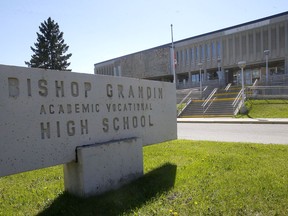 The flags at half mass at Bishop Grandin High School to honour the remains of 215 children discovered at a former residential school in Kamloops B.C. in Calgary on Monday, May 31, 2021.