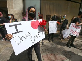 Supporters gather at 8 Ave and 4 St SW in downtown Calgary on Friday, June 11, 2021 in a show of solidarity with drug users and Calgary's supervised consumption site.