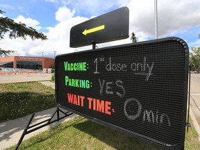 A sign encourages Calgarians who have not received their first dose of a COVID-19 vaccine outside a pop-up vaccination clinic at the Village Square Leisure Centre in northeast Calgary on Sunday, June 6, 2021.
