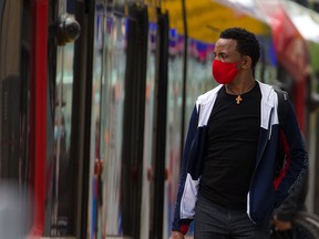 Calgarians ride the CTrain in downtown Calgary on Sunday, June 20, 2021. Council will be looking at when to lift the current mandatory mask bylaw this summer.