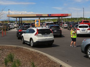 Cars line up for the cheapest gas in Calgary at the Costco on Tsuut'ina Nation on Wednesday, June 23, 2021. While many Calgary stations were advertising regular gas for 133.9 cents/litre Costco still had gas for 113 cents/litre. Gas prices are expected to spike again this summer.

Gavin Young/Postmedia