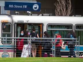 Riders wear masks while riding the CTrain on Wednesday, June 23, 2021. Mandatory masking for transit and taxis will remain when most provincial pandemic restrictions are lifted on July 1.