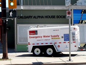 An emergency water truck has been set up outside the Alpha House as temperatures soar in Calgary on Monday, June 28, 2021.