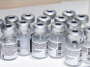 Empty vials of the Pfizer-BioNTech vaccine are seen at The Michener Institute, in Toronto. Alberta says Pfizer and Moderna are interchangeable as Canada's weekly shipment of Pfizer is delayed.