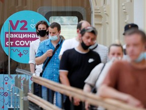 People line up to receive vaccine against COVID-19 outside a vaccination centre in the State Department Store, GUM, in central Moscow, Russia, on June 25, 2021.