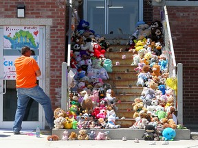 Stuffed animals and children's shoes are left on the steps of the Old Sun Community College on Siksika Nation, commemorating victims and survivors of residential schools. Ceremonies were held at the former residential school on July 1, 2021.