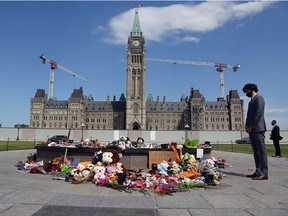 Prime Minister Justin Trudeau visits a makeshift memorial erected on Parliament Hill in honour of the 215 Indigenous children whose remains were found at the Kamloops Indian Residential School, on June 1, 2021.